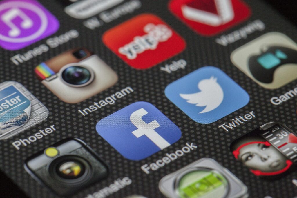 Advantages and Disadvantages of Social Media in Digital Marketing Close-up image of various social media app icons on a smartphone screen.